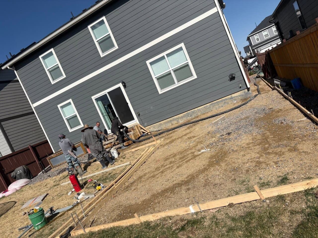 Workers preparing and grading a residential lot