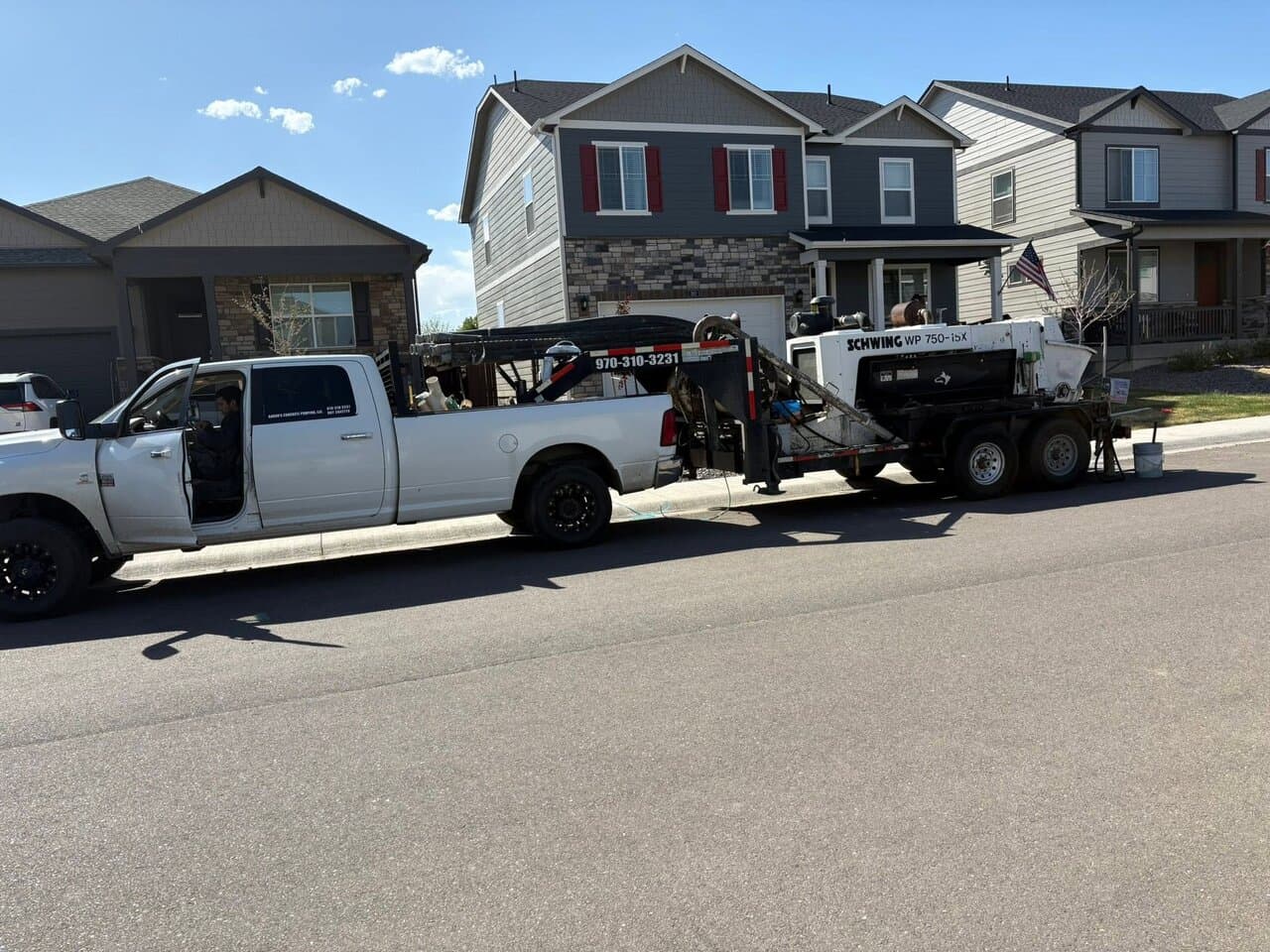 Work trucks parked in suburban street during job