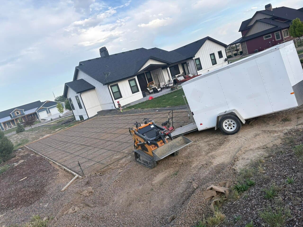 Skid-steer loader on concrete patio at residential property