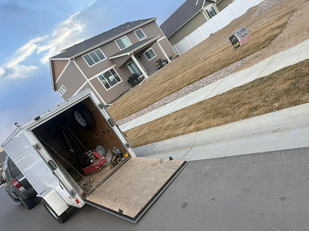 Enclosed cargo trailer with equipment and tools staged for transport