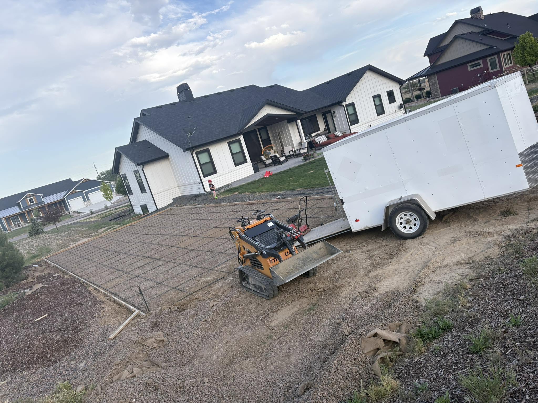 Skid-steer loader on concrete patio at residential property